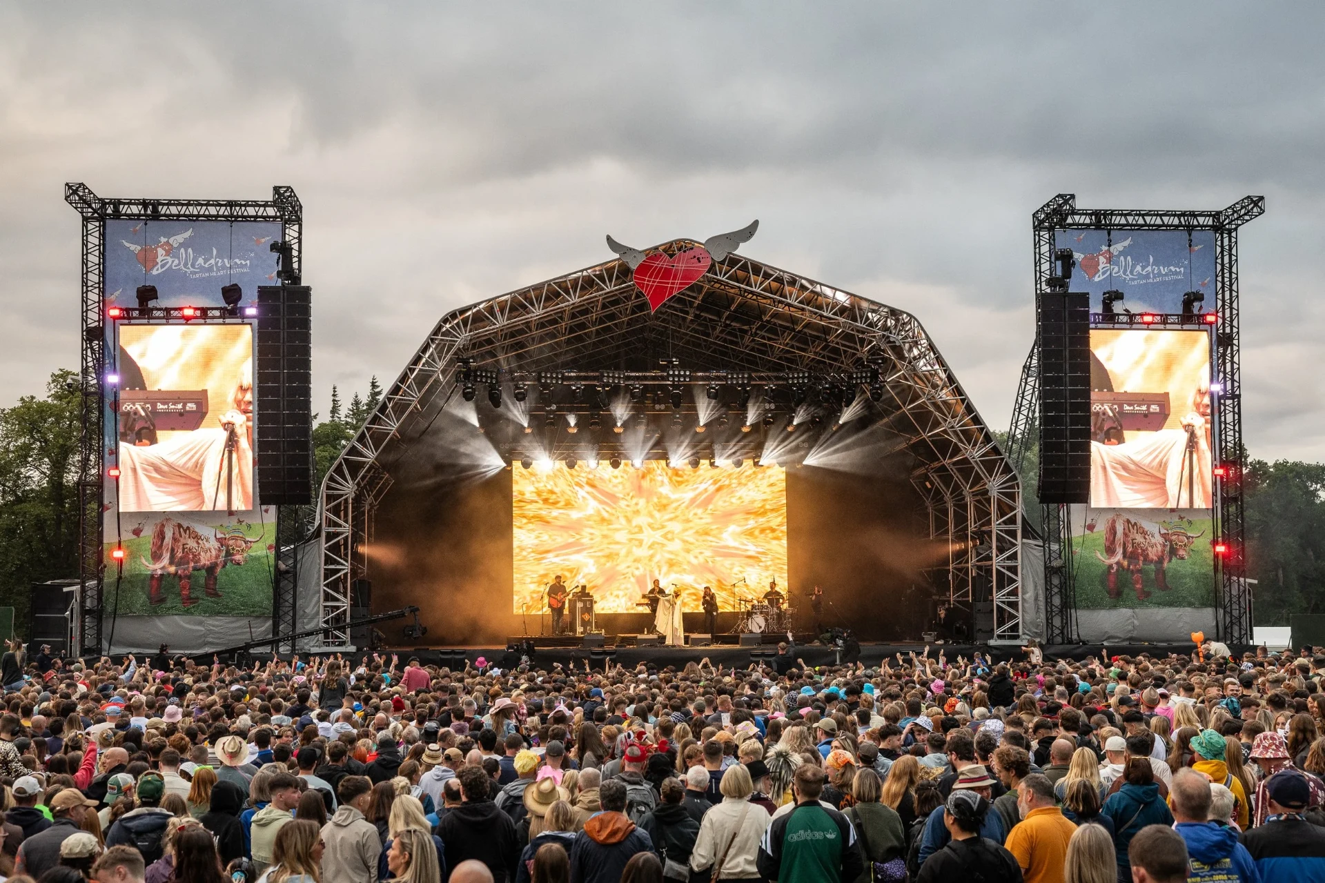 The Tartan Heart Festival main stage at Belladrum, band performing before a crowd beneath gold lit screens